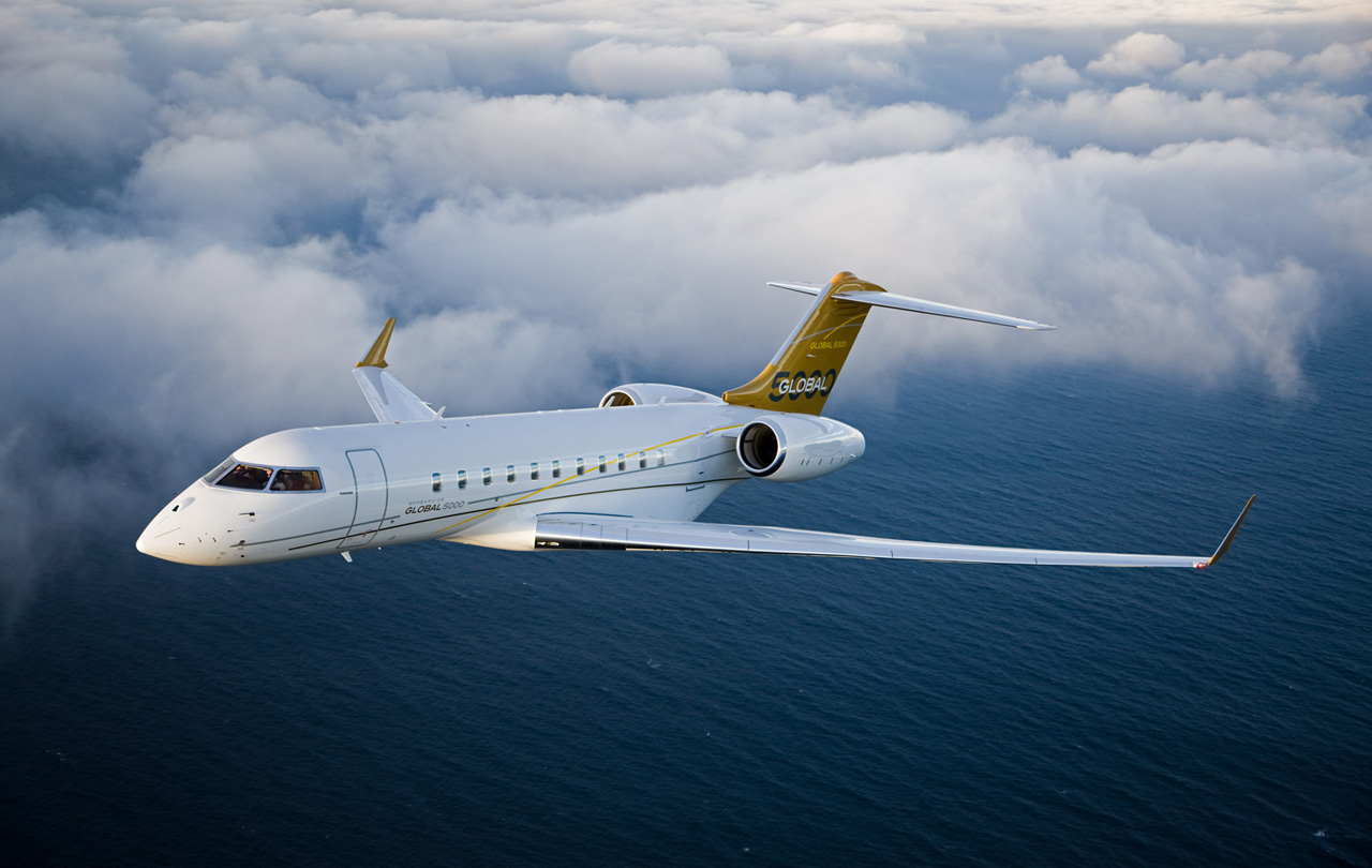 Global 5000 White and Gold Color Jet Flying in Air